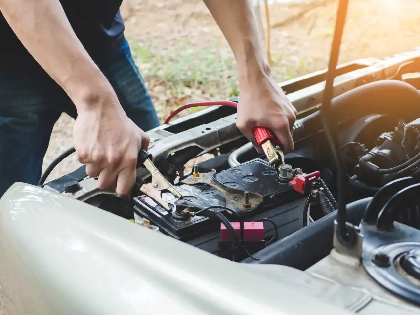 Driver dealing with a flat car battery on a cold Manchester morning